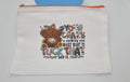 White pouch with a colorful design of a cow and text on a white background